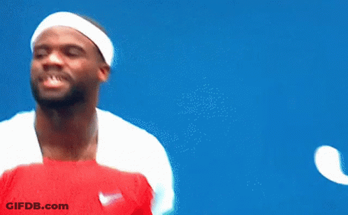 A Man Wearing A Headband And Holding A Tennis Racquet Looks Up At The Sky GIF