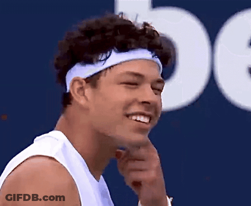 A Man Wearing A Headband Is Smiling And Looking To The Side GIF