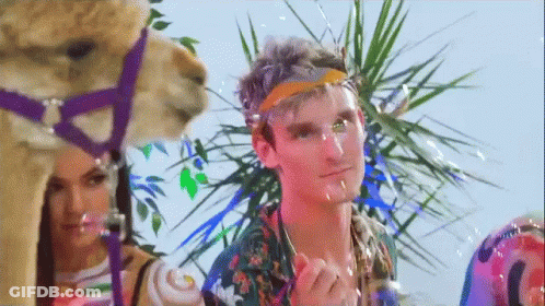 A Man Wearing A Headband Is Standing Next To A Camel . GIF