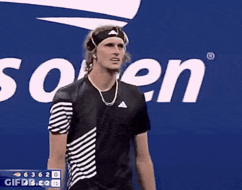 A Man Wearing A Headband Stands In Front Of A Sign That Says ' Us Open ' GIF