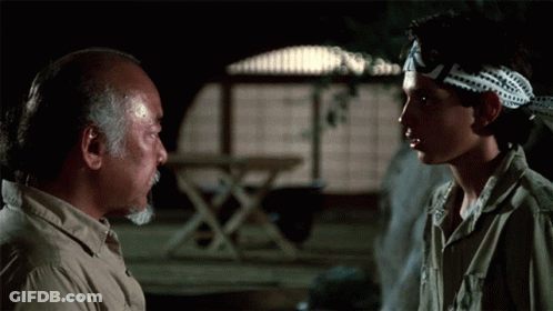 A Man Wearing A Headband That Says ' Karate Kid ' On It GIF