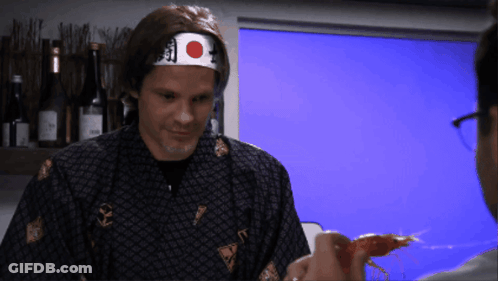 A Man Wearing A Headband With A Red And White Circle On It GIF