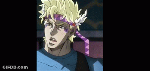 A Man Wearing A Headband With Feathers And A Flower On It GIF