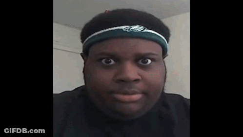 A Man Wearing A Headband With The Eagles Logo On It Looks At The Camera . GIF