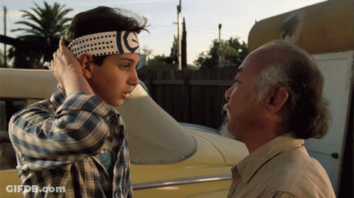A Man Wearing A Headband With The Letter E On It GIF