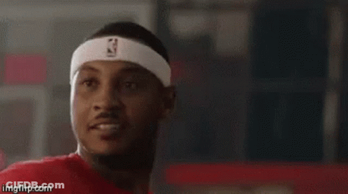 A Man Wearing A Headband With The Nba Logo On It Is Looking At The Camera . GIF