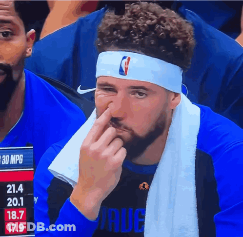 A Man Wearing A Headband With The Nba Logo On It Wipes His Nose GIF