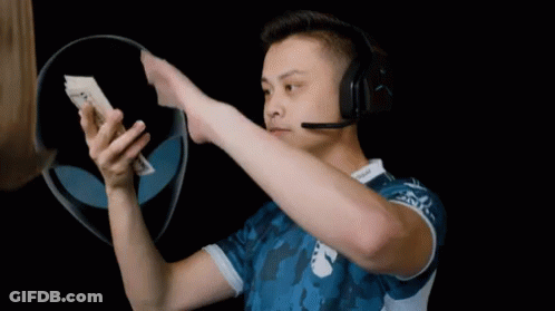 A Man Wearing A Headset Holds Up A 20 Dollar Bill GIF