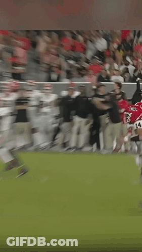 A Man Wearing A Headset Is Running On A Field GIF