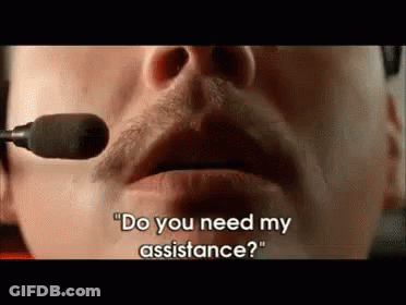A Man Wearing A Headset Is Talking Into A Microphone And Asking If He Needs Assistance . GIF