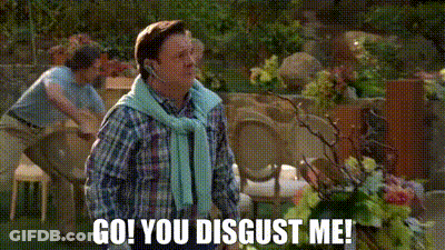 A Man Wearing A Headset Says `` Go ! You Disgust Me ! '' While Standing In A Garden . GIF