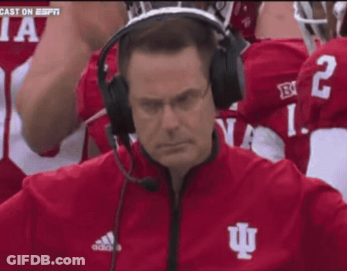 A Man Wearing A Headset With The Letter I On His Jacket GIF