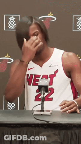 A Man Wearing A Heat 22 Jersey Is Sitting At A Table GIF
