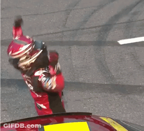 A Man Wearing A Helmet And A Jersey With The Number 5 On It Is Raising His Hands In The Air GIF