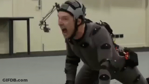 A Man Wearing A Helmet And A Suit Is Screaming While Kneeling On The Floor . GIF