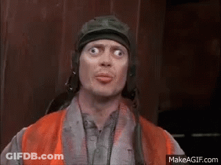 A Man Wearing A Helmet And An Orange Vest Making A Funny Face . GIF