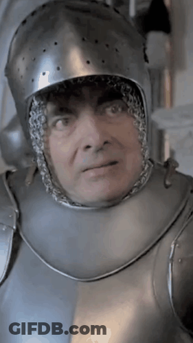A Man Wearing A Helmet And Armor Looks At The Camera GIF