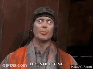 A Man Wearing A Helmet And Goggles Is Making A Funny Face . GIF