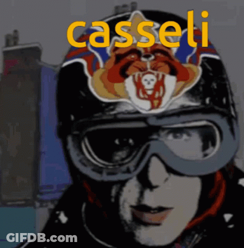 A Man Wearing A Helmet And Goggles With The Name Casseli Written In Yellow GIF