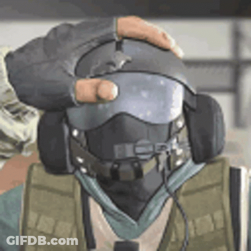 A Man Wearing A Helmet And Headphones Is Being Held By Another Man . GIF