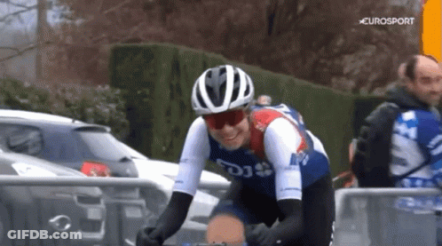 A Man Wearing A Helmet And Sunglasses Is Riding A Bike With Eurosport In The Background GIF