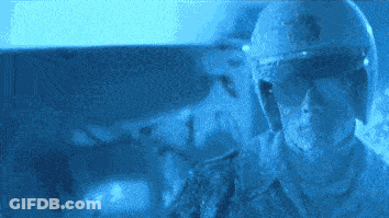 A Man Wearing A Helmet And Sunglasses Looks At Something GIF