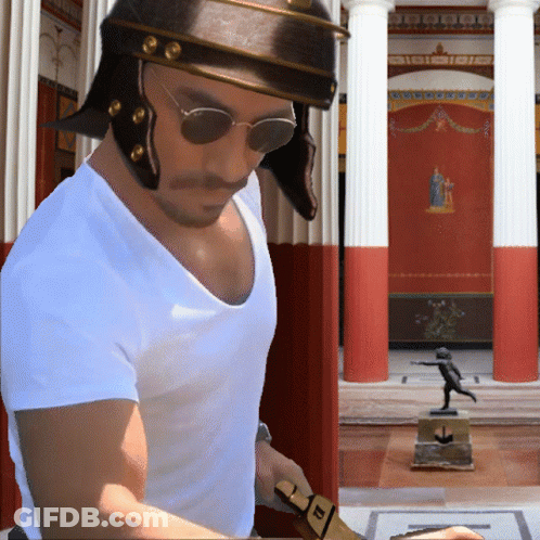 A Man Wearing A Helmet And Sunglasses Stands In Front Of A Building With Columns GIF
