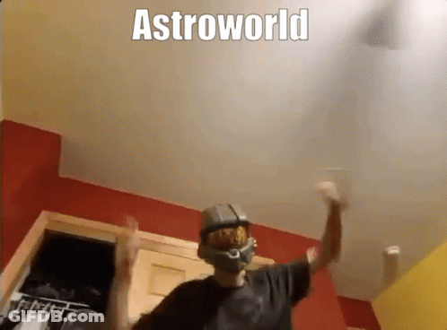 A Man Wearing A Helmet Is Dancing In A Room With The Words Astroworld Above Him . GIF