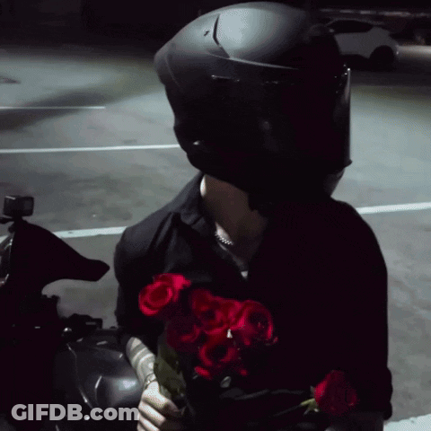 Man With Helmet Holding Roses GIF