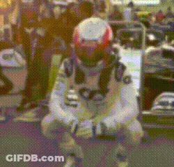 A Man Wearing A Helmet Is Kneeling Down On The Ground . GIF