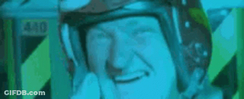 A Man Wearing A Helmet Is Making A Funny Face And Saying `` Hello '' . GIF