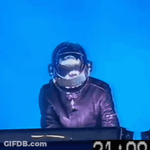 A Man Wearing A Helmet Is Playing A Keyboard With A Clock That Says 21:00 On It GIF