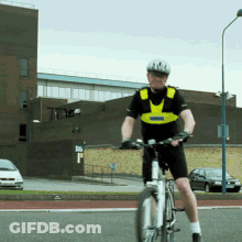 A Man Wearing A Helmet Is Riding A Bike GIF