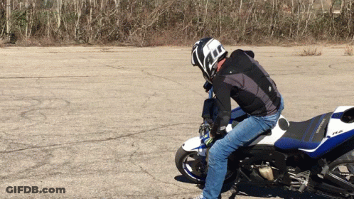 A Man Wearing A Helmet Is Riding A Motorcycle GIF