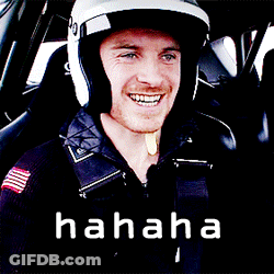 A Man Wearing A Helmet Is Smiling In A Car With The Word Hahaha Written Below Him GIF