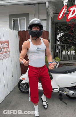 A Man Wearing A Helmet Is Standing In Front Of A Sign That Reads Authorized Parking Only GIF