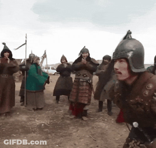 A Man Wearing A Helmet Is Surrounded By Other Men In Armor GIF
