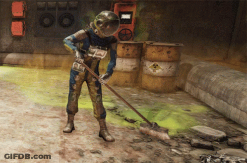 A Man Wearing A Helmet Is Sweeping The Ground In Front Of Barrels With A Warning Sign On Them GIF