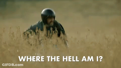 A Man Wearing A Helmet Is Walking Through A Field And Asking Where The Hell Am I . GIF