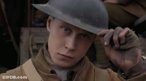 A Man Wearing A Helmet Looks At The Camera With A Serious Look On His Face GIF