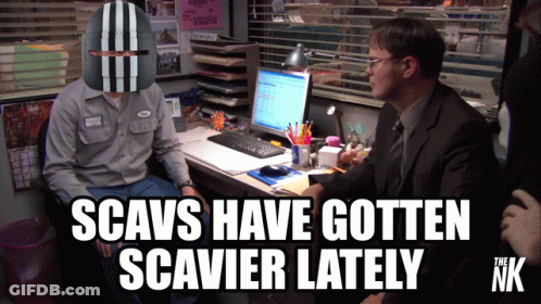 A Man Wearing A Helmet Sits At A Desk With The Words Scavs Have Gotten Scavier Lately GIF