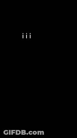 A Man Wearing A Helmet Stands In Front Of A Smokey Mountain GIF