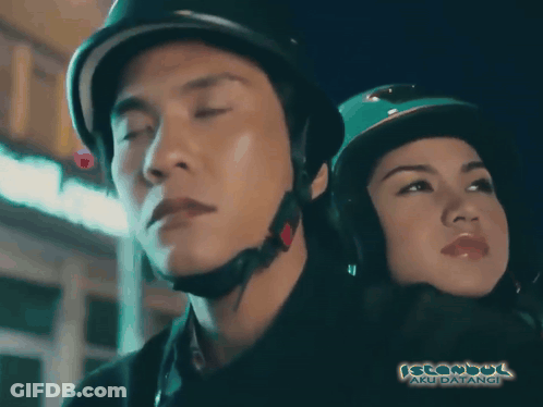 A Man Wearing A Helmet Stands Next To A Woman Wearing A Hijab And The Words Istanbul Aku Datangi Are Visible GIF
