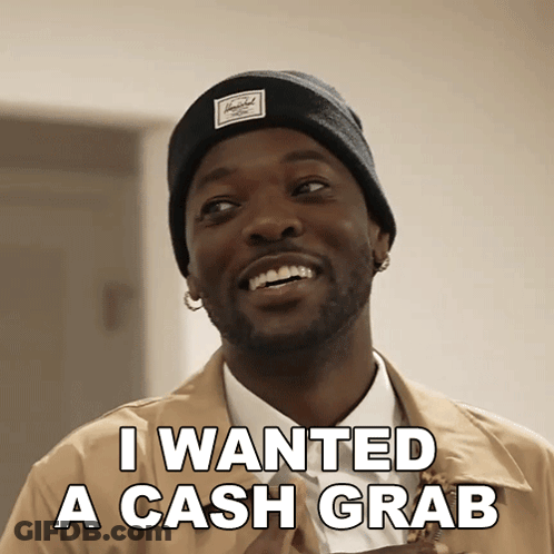 A Man Wearing A Herschel Beanie Is Smiling And Says I Wanted A Cash Grab GIF