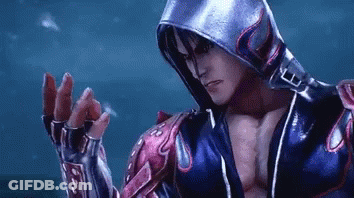A Man Wearing A Hooded Jacket And Gloves Is Standing In Front Of A Blue Background . GIF