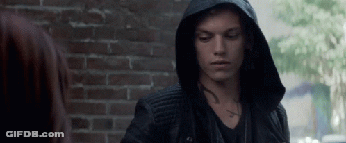 A Man Wearing A Hooded Jacket Has A Tattoo On His Chest GIF