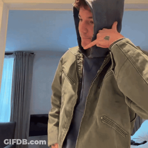 A Man Wearing A Hooded Jacket Has A Tattoo On His Finger That Says ' I Love You ' GIF