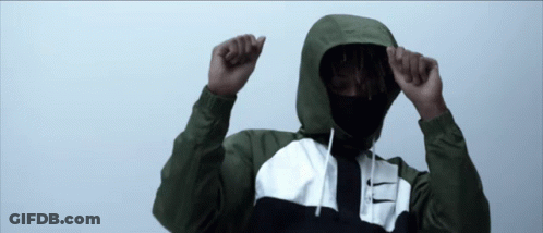 A Man Wearing A Hooded Jacket With A Nike Logo On The Front GIF