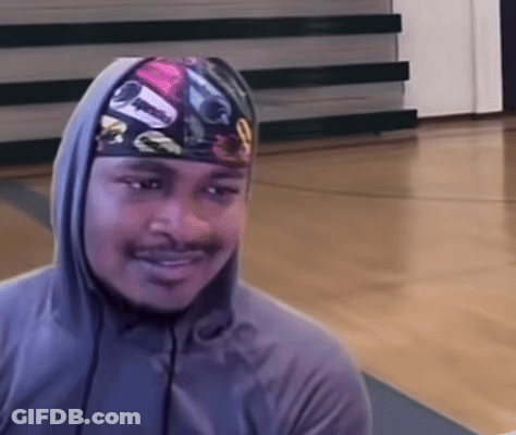 A Man Wearing A Hooded Sweatshirt And A Headband With A Picture Of A Car On It Is Smiling GIF