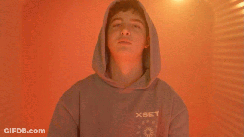 A Man Wearing A Hooded Sweatshirt Is Asking What Do You Rep GIF